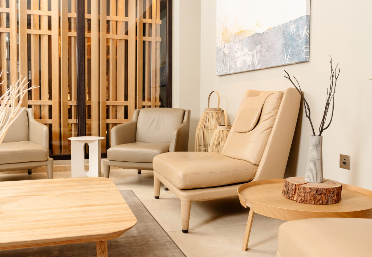 A modern living room with a light gray rug, wooden furniture, and a sense of tranquility.