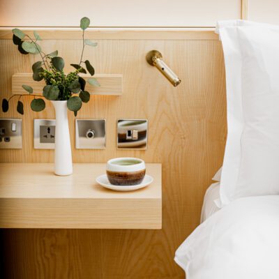 Luxury Hotel Suite with A cup of green tea on a bedside table