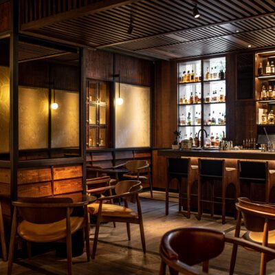 The Malt Lounge and Bar, a dimly lit, modern bar with a wooden counter, high chairs