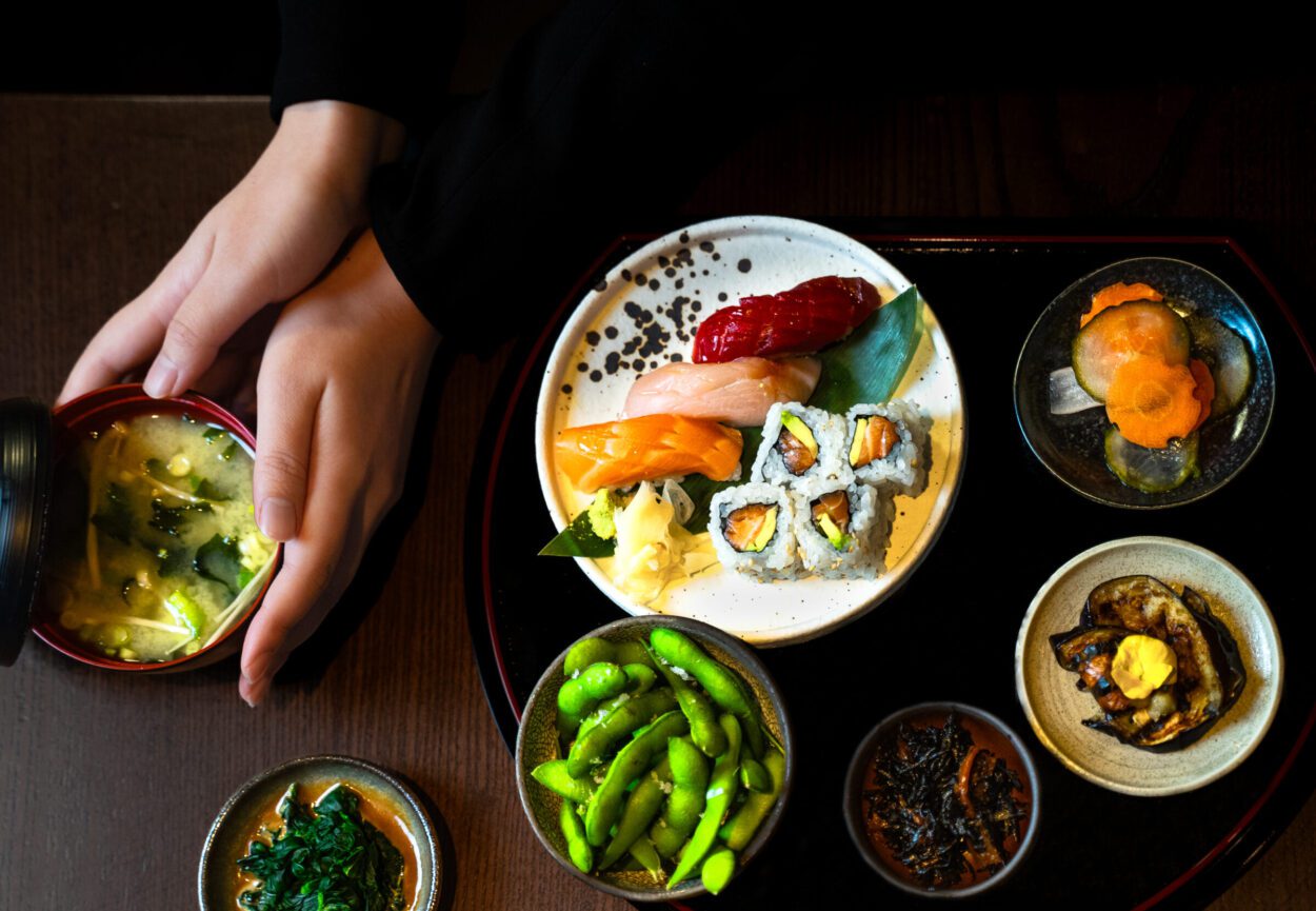 Sushi bento box provided by TOKii restaurant, featuring several small plates of authentic Japanese fusion food.