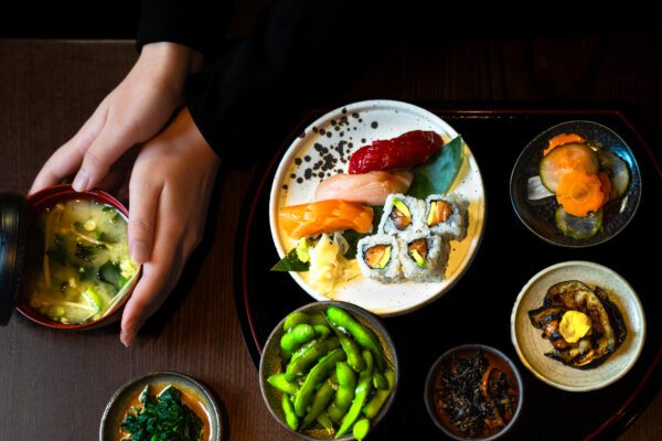 Sushi bento box provided by TOKii restaurant, featuring several small plates of authentic Japanese fusion food.