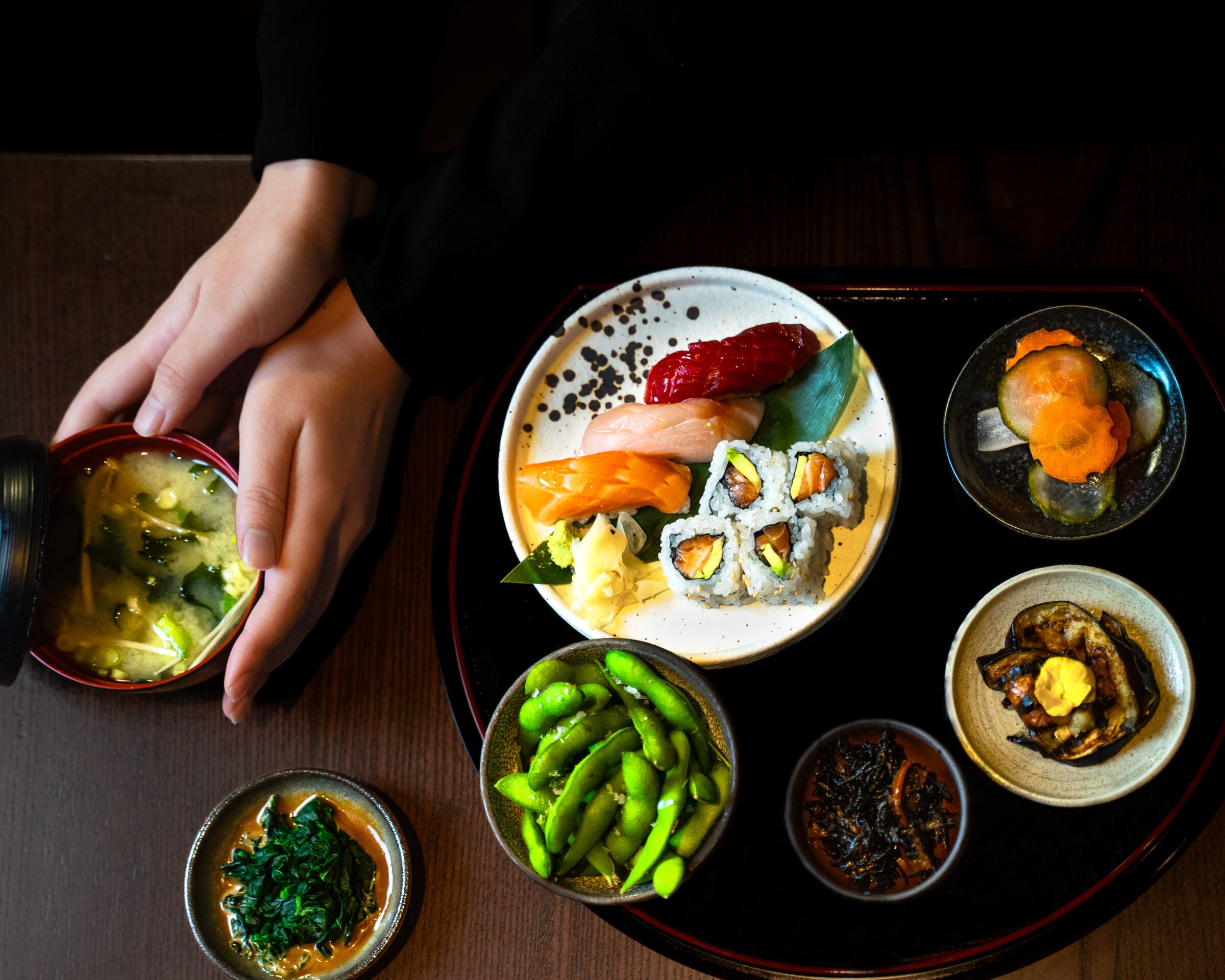 Sushi bento box provided by TOKii restaurant, featuring several small plates of authentic Japanese fusion food.