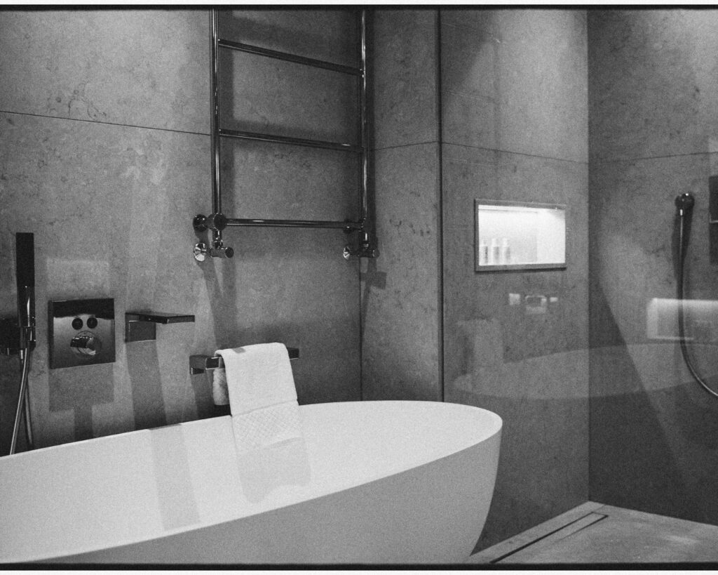 Japanese-inspired hotel bathroom with a deep soaking bath and calming contemporary design.