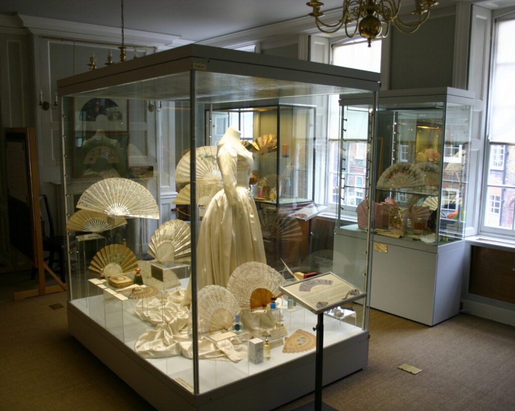 Decorative historic hand fans displayed in elegant museum cases