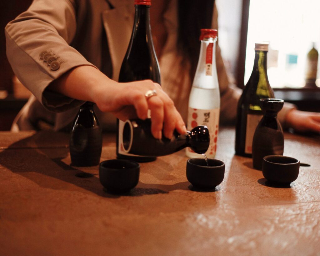An expert pours Japanese sake at The Malt Lounge & Bar.