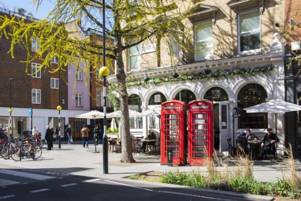 Red telephone boxes on Marylebone High Street, a boutique shopping destination in London